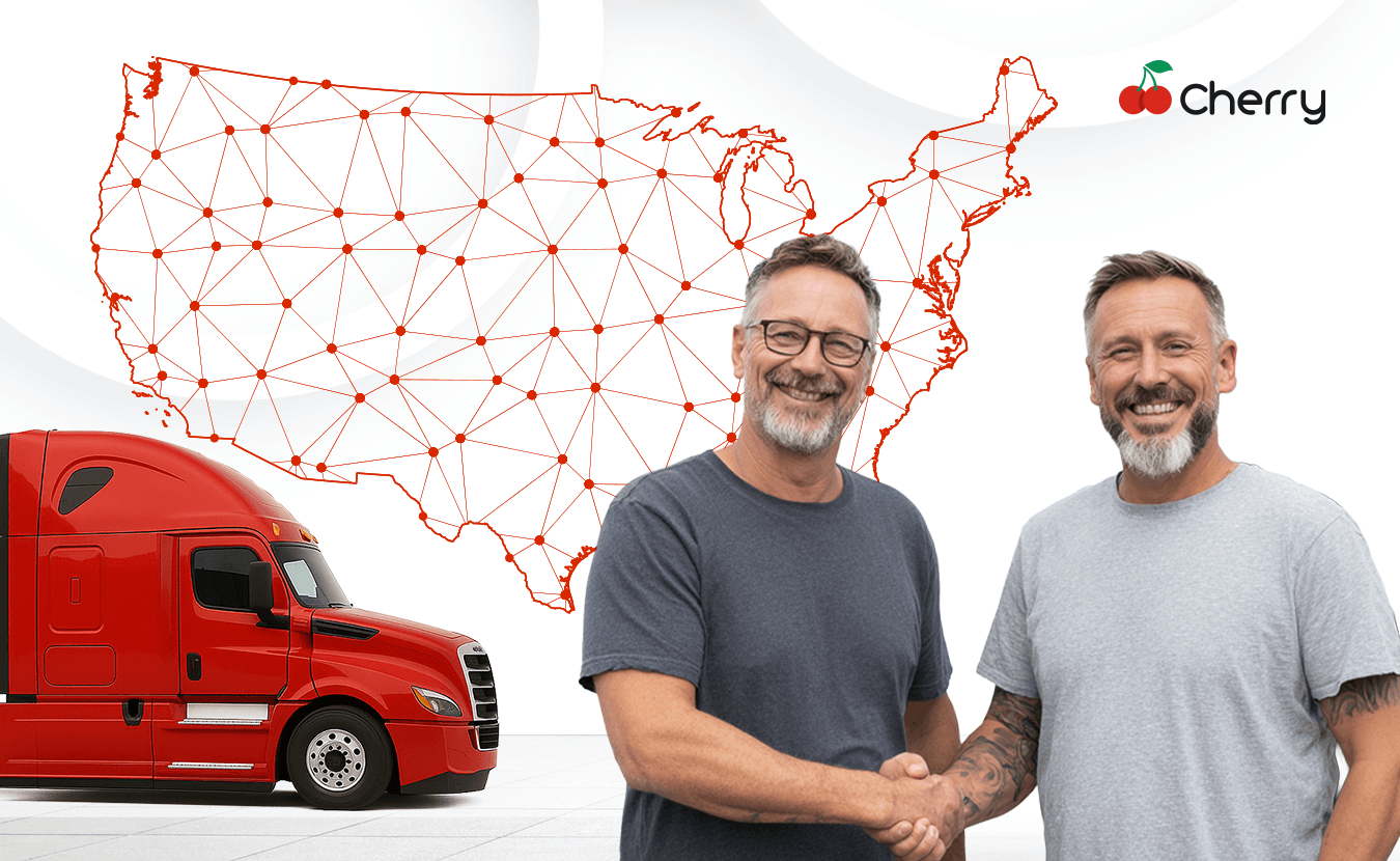 Two truckers shaking hands in front of a truck with a U.S. map and Cherry Trader message about reaching buyers nationwide.
